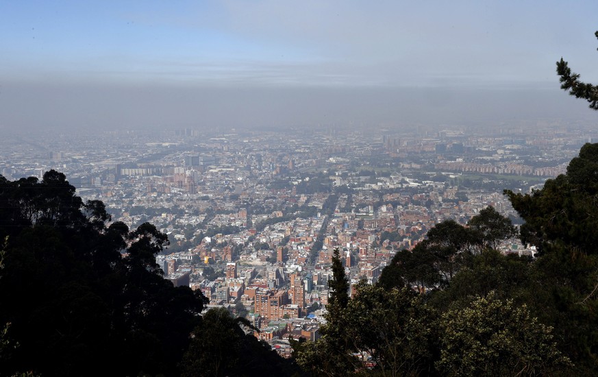 epa11104065 A layer of smoke over the city caused by forest fires in Bogota, Colombia, 25 January 2024. A total of 31 forest fires are active in Colombia and affect nine departments and Bogota, where  ...