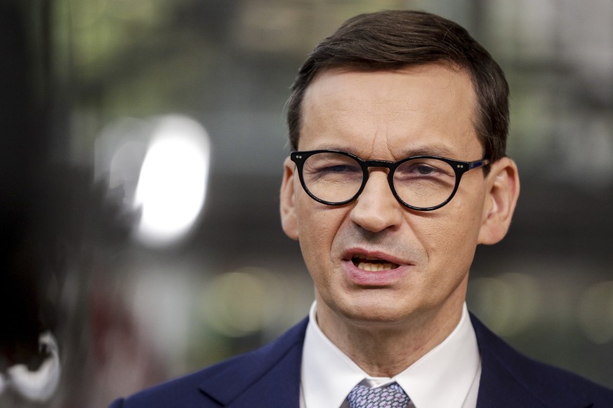 Poland&#039;s Prime Minister Mateusz Morawiecki talks to journalists as he arrives for an EU summit in Brussels, Thursday, Oct. 21, 2021. European Union leaders head into a standoff between Poland and ...