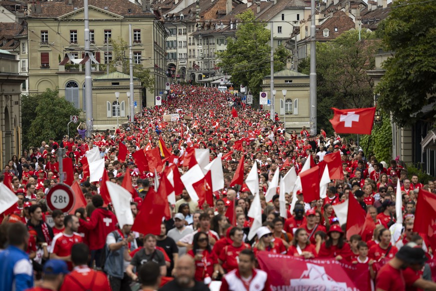 Swiss fans walk from old town in Bern over the Nydegg bridge towards the stadium during a fanwalk prior to the UEFA Women&#039;s EURO 2025 Group A soccer match between Switzerland and Iceland at the W ...