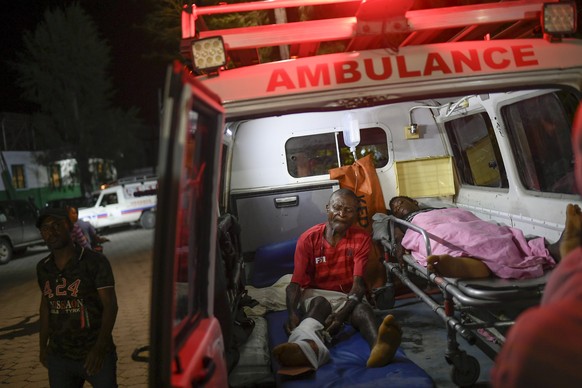 Injured people sit in the ambulance that transferred them from another town to the Immaculee Conception hospital in Les Cayes, Haiti, Tuesday, Aug. 17, 2021, three days after an earthquake struck the  ...