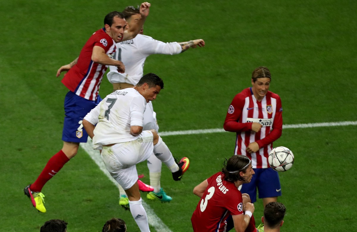 Real Madrid's Cristiano Ronaldo fights for the ball against Atletico's Fernando Torres and Filipe Luis during the Champions League final soccer match between Real Madrid and Atletico Madrid  ...