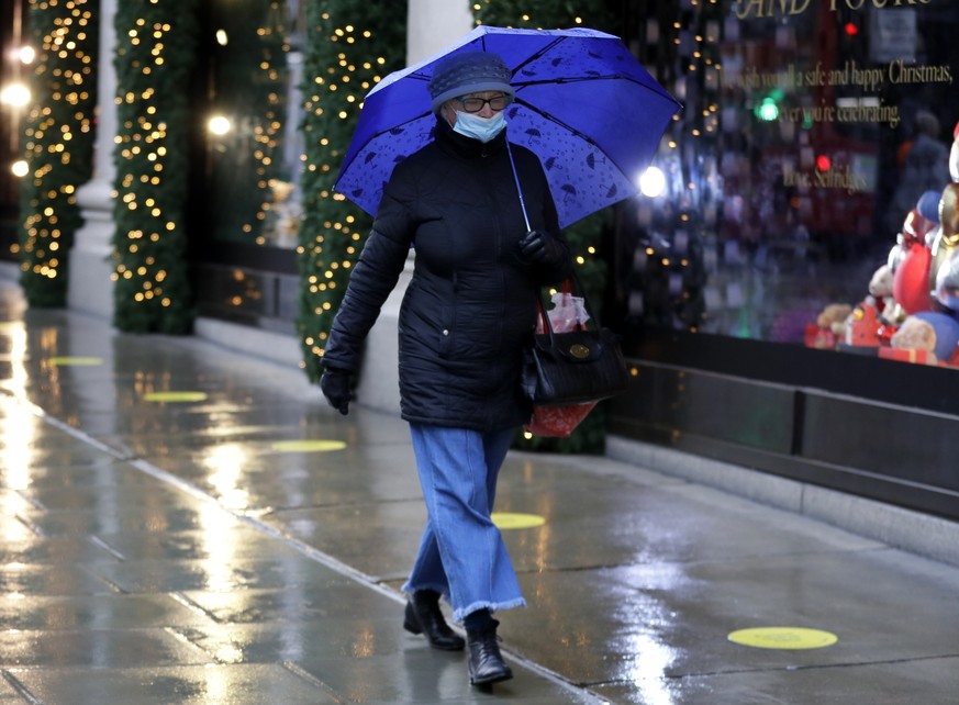 A pedestrian passes Christmas decorations of a closed shop in Oxford Street in London, Wednesday, Dec. 23, 2020. Britain&#039;s Prime Minister Boris Johnson imposed a new, higher level of coronavirus  ...