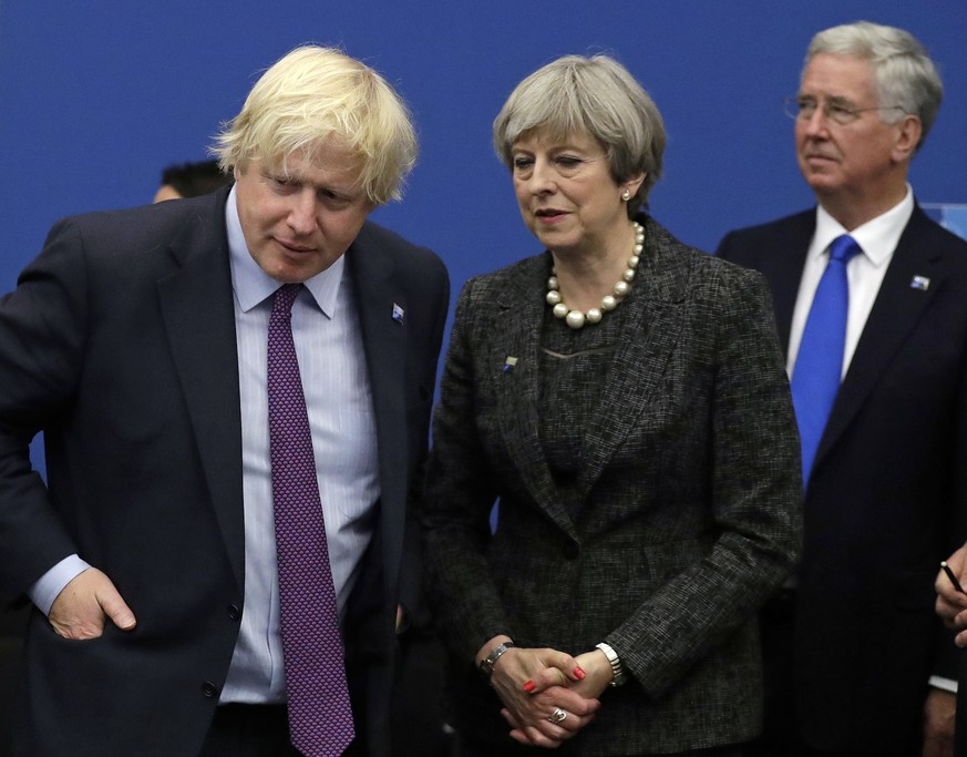 FILE - In this file photo dated Thursday, May 25, 2017, British Prime Minister Theresa May talks with British Foreign Minister Boris Johnson, with British lawmaker Michael Fallon, right, as they parti ...