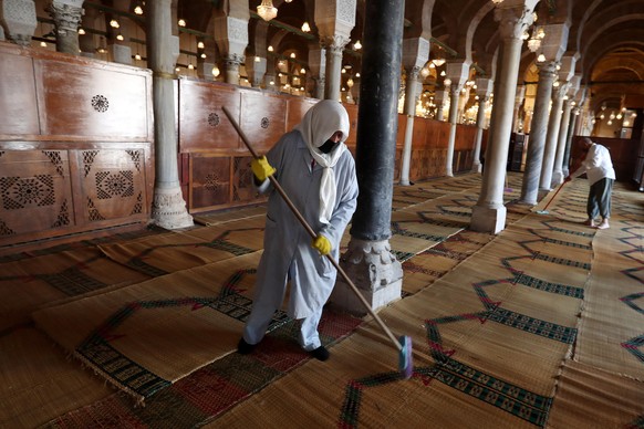 epa08462456 Workers sweep at Al-Zaytuna Mosque in Tunis, Tunisia, 03 June 2020. The mosques will be reopened on 04 June for the first time since they were closed on 13 March as a measure against the s ...