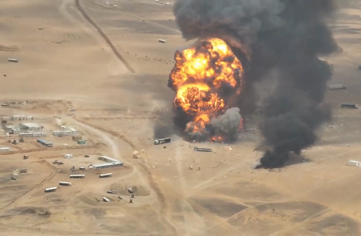 epa13220607 A handout screen grab taken from a video released on 07 September 2026 made available by the Houthi military media center shows smoke and balls of fire rising from trucks at a camp of the  ...