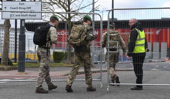 epa08338935 Military personnel outside the Nightingale Hospital at the ExCel conference center in London, Britain, 02 April 2020. The temporary hospital is suppose to be ready to take care of coronavi ...