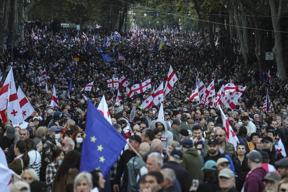 epa12430326 Georgian opposition party supporters attend a rally during local elections in Tbilisi, Georgia, 04 October 2025. Elections to local governments are held in Georgia on 04 October, where mem ...