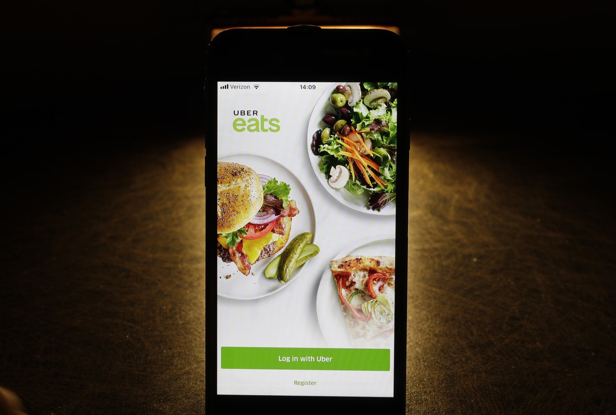 FILE - In this Feb. 20, 2018, file photo shows the Uber Eats app on an iPhone in Chicago. Uber is testing restaurant food deliveries by drone. The company's Uber Eats unit began the tests in San  ...