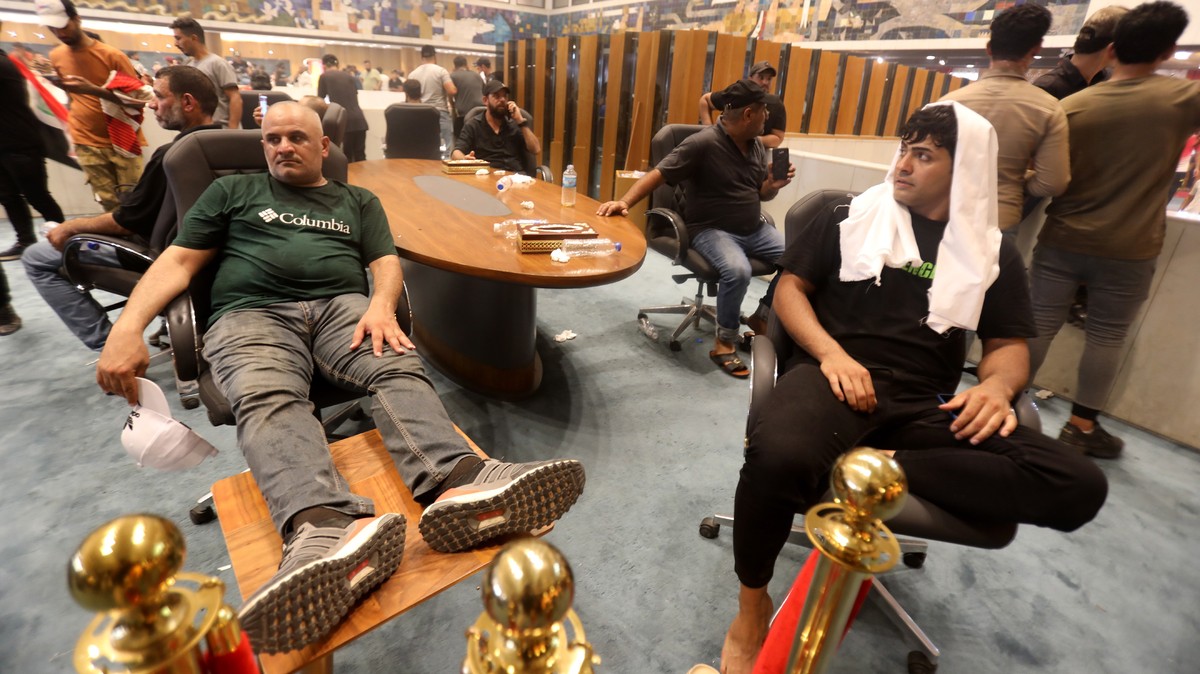 epa10098539 Supporters of Iraqi Shiite cleric Muqtada al-Sadr, head of the Sadrist movement, gather inside the Iraqi parliament hall after they stormed the 'Green Zone' in central Baghdad, I ...