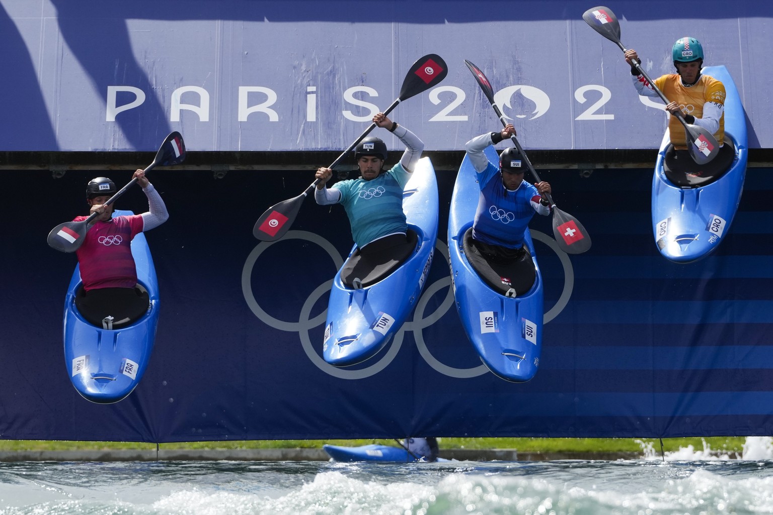 Boris Neveu of France competes in the men&#039;s kayak cross heat against Salim Jemai of Tunisia, Martin Dougoud of Switzerland and Matija Marinic of Croatia during the canoe slalom at the 2024 Summer ...