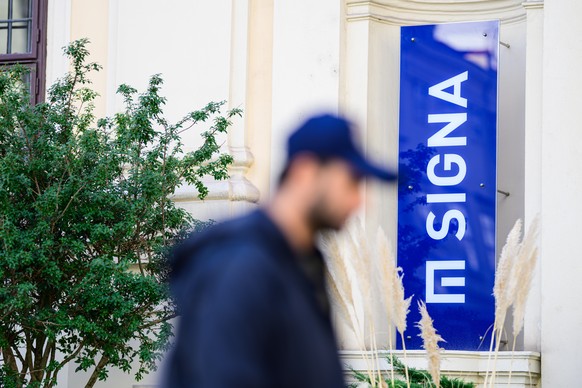 epa10964328 A man passes by a logo of Austrian real estate and trading company Signa Holding at the group&#039;s Vienna office, in Vienna, Austria, 08 November 2023. Rene Benko, Austrian business man  ...