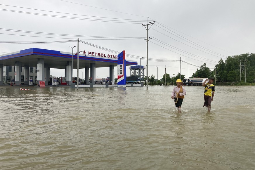 Local residents wade through a flooded road in Bago, about 80 kilometers (50 miles) northeast of Yangon, Myanmar, Monday, Oct. 9, 2023. Flooding triggered by heavy monsoon rains in Myanmar?s southern  ...
