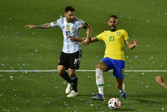 Brazil's Matheus Cunha, right, and Argentina's Lionel Messi battle for the ball during a qualifying soccer match for the FIFA World Cup Qatar 2022 at Bicentenario stadium in San Juan, Argent ...