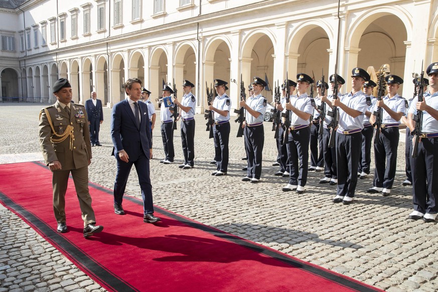 epa07800601 A handout photo made available by the Quirinal Press Office shows Italian Prime Minister Giuseppe Conte (R) arrives a the Quirinal Palace to meet President Sergio Mattarella, in Rome, Ital ...