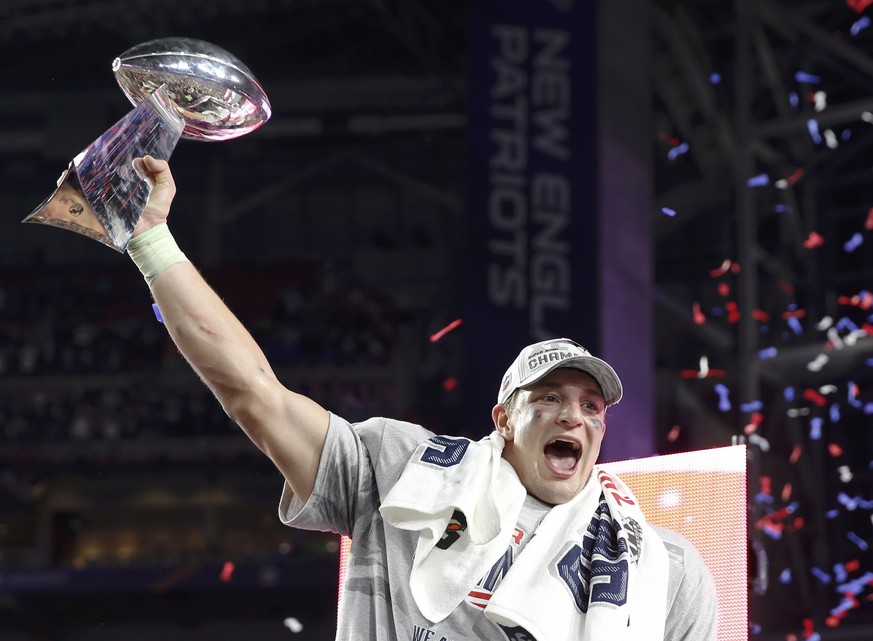 New England Patriots tight end Rob Gronkowski holds up the Vince Lombardi Trophy after his team defeated the Seattle Seahawks in the NFL Super Bowl XLIX football game in Glendale, Arizona, February 1, ...