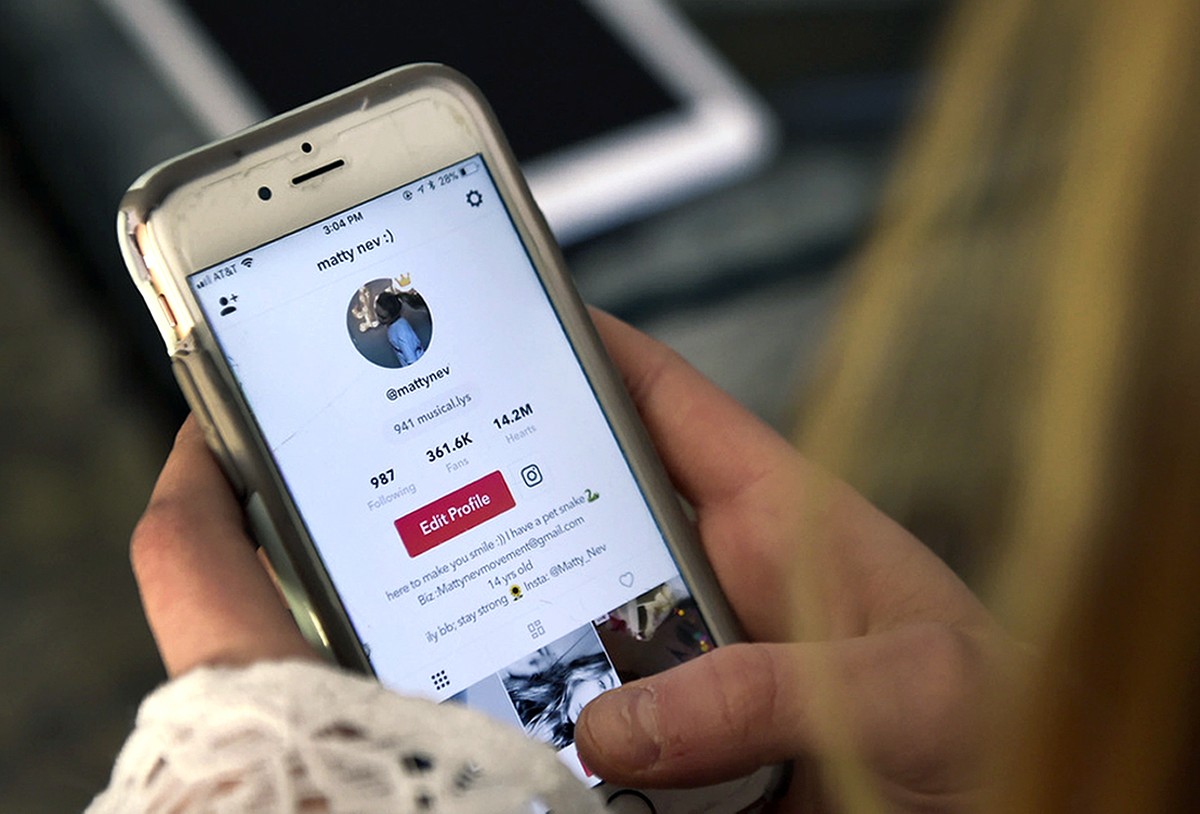 FILE - In this Feb. 28, 2018 photo, Matty Nev Luby holds her phone and logs into the lip-sync smartphone app Musical.ly, in Wethersfield, Conn. The operator of the video-sharing app popular with teena ...