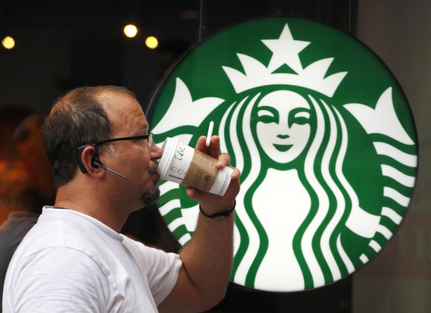 FILE - In this July 11, 2013 file photo, a man drinks a Starbucks coffee in New York. Starbucks says its hiking prices again starting Tuesday, July 7, 2015, with the increases ranging from 5 to 20 ce ...