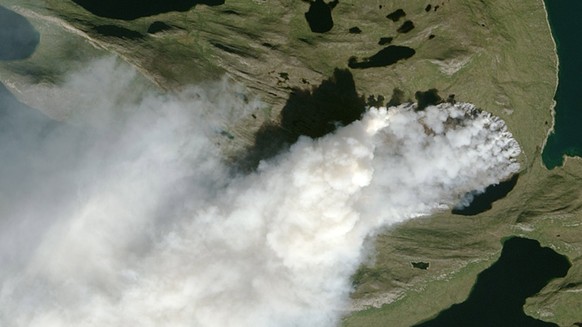epa06153446 A handout photo made available on 20 August 2017 by Nasa Earth Observatory showing a wildfire burning in western Greenland, about 150 kilometers (90 miles) northeast of Sisimiut on 03 Augu ...