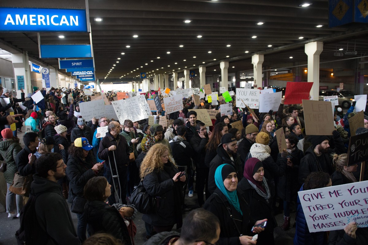 epa05760455 Demonstrators gather to protest against US President Trump's travel ban executive orders, outside of the international arrivals terminal at Philadelphia International Airport in Phila ...