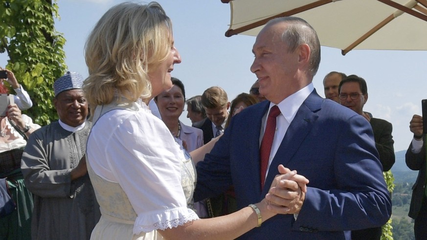 Russian President Vladimir Putin, right, congratulates Austrian Foreign Minister Karin Kneissl as he attends the wedding of Kneissl with Austrian businessman Wolfgang Meilinger in Gamlitz, southern Au ...