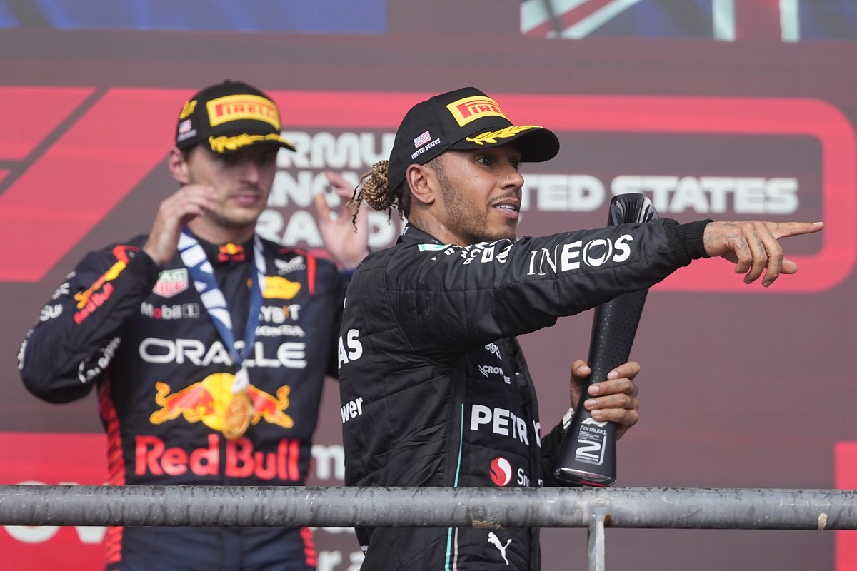 Mercedes driver Lewis Hamilton, of Britain, celebrates on the podium in front of Red Bull driver Max Verstappen, of the Netherlands, after the Formula One U.S. Grand Prix auto race at Circuit of the A ...