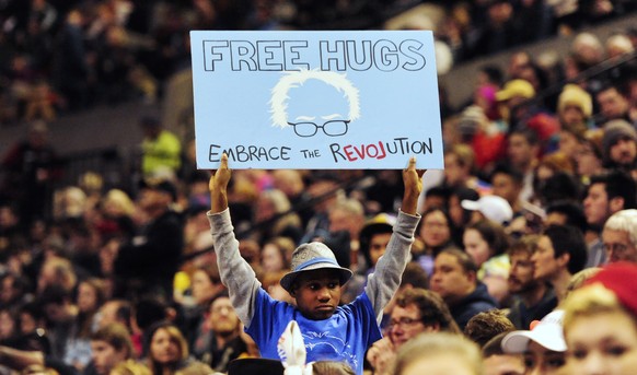 CORRECTS SOURCE-This photo taken March 25, 2016, shows a young supporter holding up a sign as then Democratic presidential candidate Bernie Sanders, I-Vt., addressed the crowd during a rally at the Mo ...