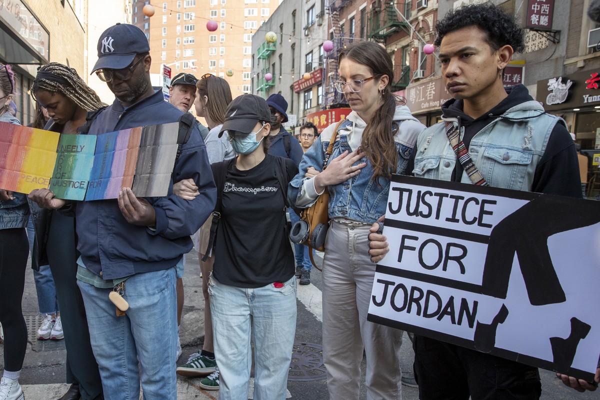 epa10639804 People lock arms and pray in honor of Jordan Neely on the day of Neely's funeral, near the New York City Police precinct on Elizabeth Street in New York, New York, USA, 19 May 2023. 3 ...