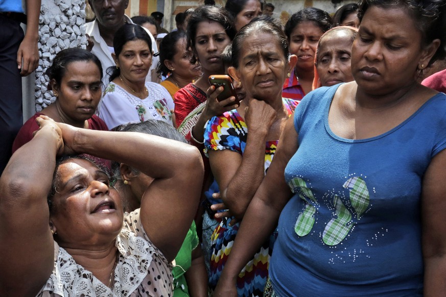 epa05908666 A Sri Lankan female mourns her dead relative after a garbage mountain collapsed in Colombo, Sri Lanka 15 April 2017. A fire broke out at a garbage dump that had grown into a huge man-made  ...