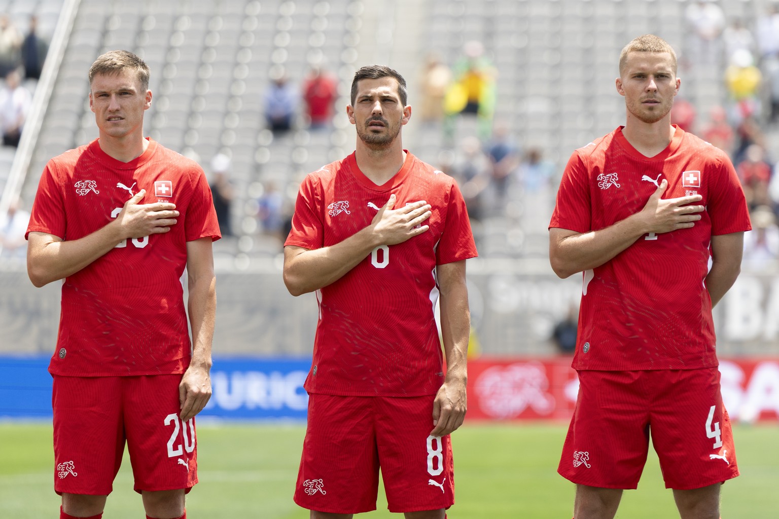 Switzerland's Michel Aebischer, Remo Freuler and Nico Elvedi, from left, sing the national anthem prior to a friendly soccer match between Switzerland and Australia at the Snapdragon Stadium in S ...