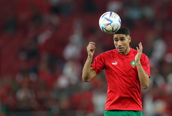 epa10359042 Achraf Hakimi of Morocco warms up prior to the FIFA World Cup 2022 quarter final soccer match between Morocco and Portugal at Al Thumama Stadium in Doha, Qatar, 10 December 2022. EPA/Fried ...