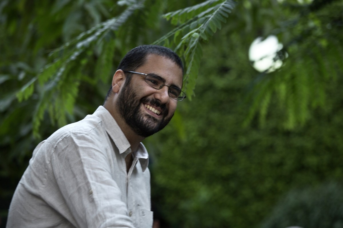 FILE - In this Monday, Sept. 22, 2014 photo, Egypt's most prominent activist Alaa Abdel-Fattah greets people prior to a conference held at the American University in Cairo, near Tahrir Square, Eg ...