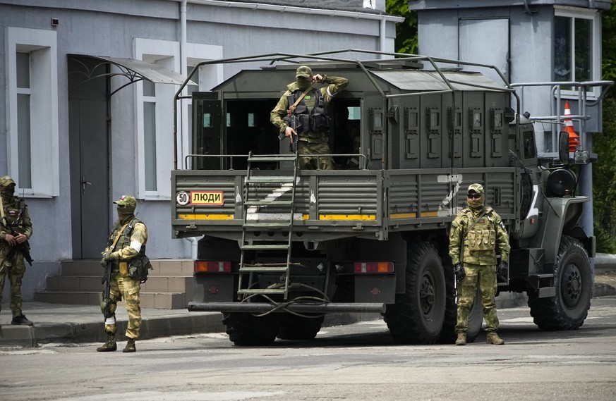 FILE - Russian soldiers guard an area as a group of foreign journalists visit in Kherson, Kherson region, south Ukraine, May 20, 2022. The Kherson region has been under control of the Russian forces s ...