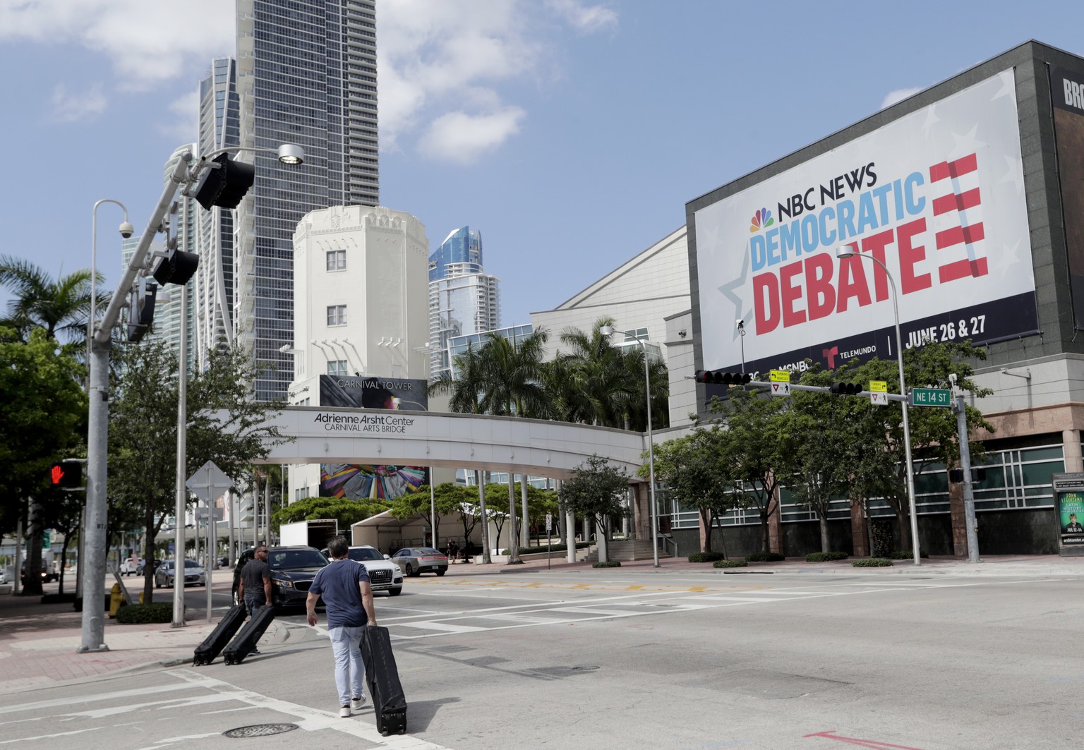 In this June 24, 2019, photo, a billboard advertises the Democratic Presidential Debates across from the Knight Concert Hall at the Adrienne Arsht Center for the Performing Arts of Miami-Dade County,  ...