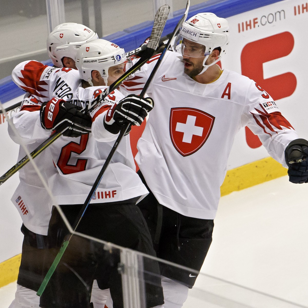 Switzerland's forward Enzo Corvi, left, celebrates his gaol with teammate forward Nino Niederreiter, 2nd left, defender Roman Josi, 2nd right, and defender Dean Kukan, right, after scoring the 1: ...