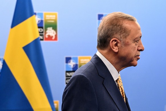epa10737953 Turkish President Recep Tayyip Erdogan looks on during his meeting with the Swedish prime minister and the Secretary General of NATO ahead of the NATO ?summit in Vilnius, Lithuania, 10 Jul ...