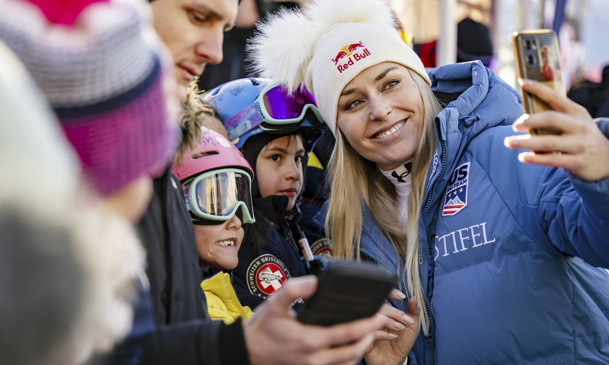 United States' Lindsey Vonn, takes a selfie in the finish area after completing an alpine ski, women's World Cup super G, in St. Moritz, Switzerland, Saturday, Dec. 21, 2024. (Jean-Christoph ...