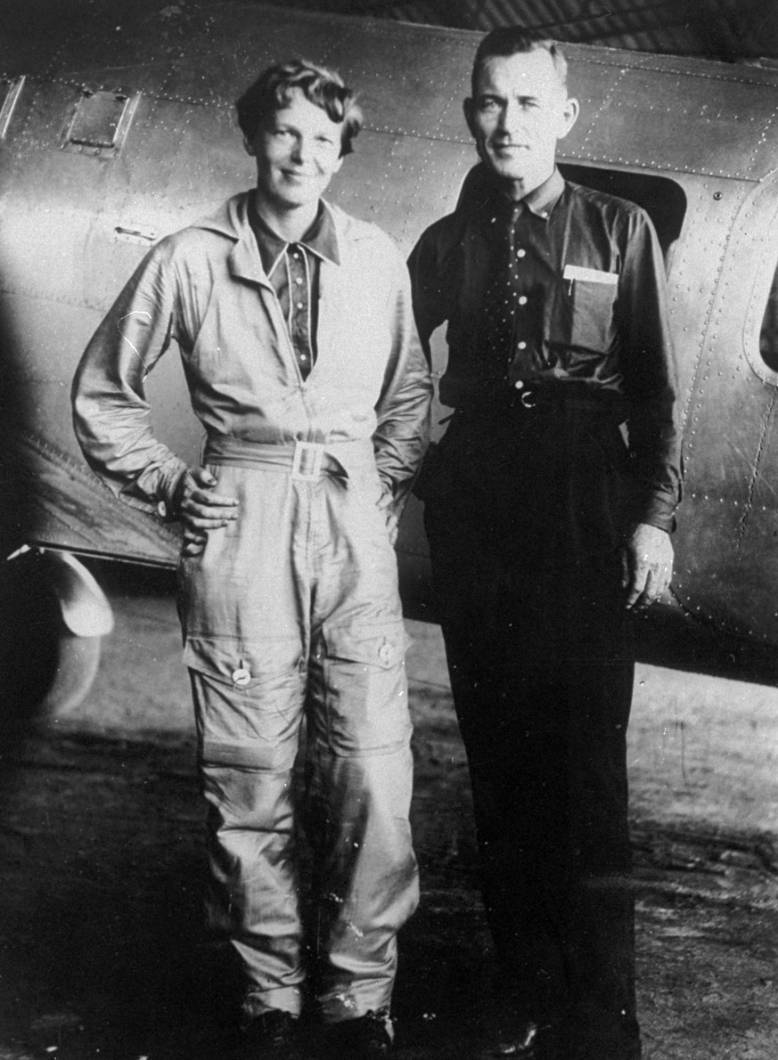 FILE - In this May 1937 file photo, aviator Amelia Earhart and her navigator, Fred Noonan, stand in front of their twin-engine Lockheed Electra airplane in Los Angeles, prior to their historic flight  ...