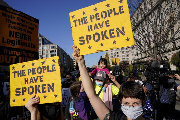FILE - In this Nov. 6, 2020, file photo, protestors march through Black Lives Matter Plaza near the White House during a Count Every Vote rally in Washington. President Donald Trump and his allies hav ...