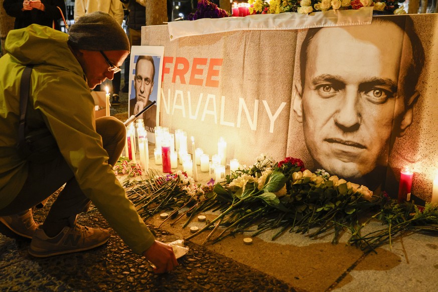 Pavel Shumilkin lights candles for a vigil held for Alexei Navalny outside City Hall in San Francisco, Friday, Feb. 16, 2024. Navalny, who crusaded against Russian corruption and staged massive anti-K ...