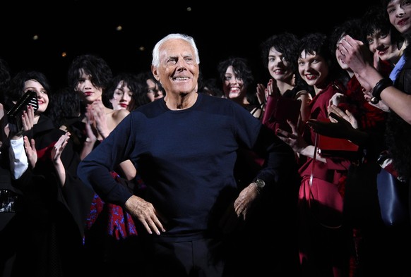 epa12351787 (FILE) - Italian designer Giorgio Armani (C) poses with models at the end of the presentation of his Fall/Winter 2015/16 Women&#039;s collection for his label Emporio Armani during the Mil ...