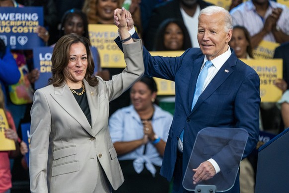 epa11550495 US President Joe Biden (R) and presumptive Democratic Presidential nominee, Vice President Kamala Harris, depart the stage following their remarks on the progress they are making to lower  ...