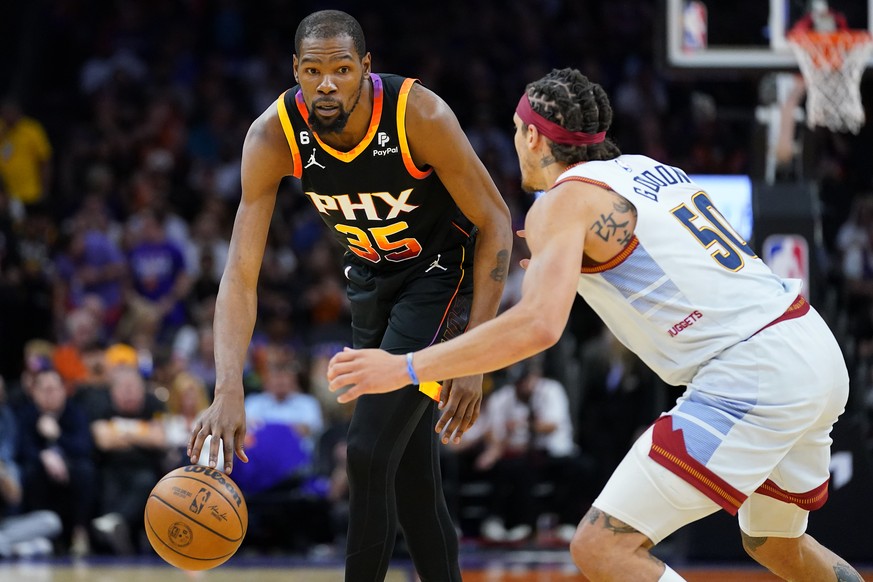 Phoenix Suns forward Kevin Durant, 35, looks to drive over Denver Nuggets forward Aaron Gordon, 50, during the first half of Game 3 of the Western Conference semifinals, Friday, May 5,…