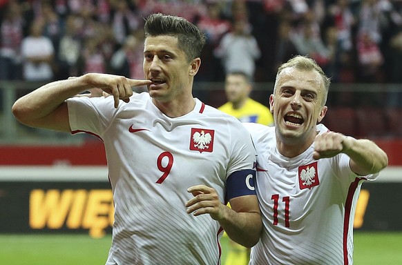 FILE - In this Monday, Sept. 4, 2017 filer, Poland&#039;s Robert Lewandowski,left, celebrates scoring their third goal from the penalty spot with Kamil Grosicki during the World Cup Group E qualifying ...