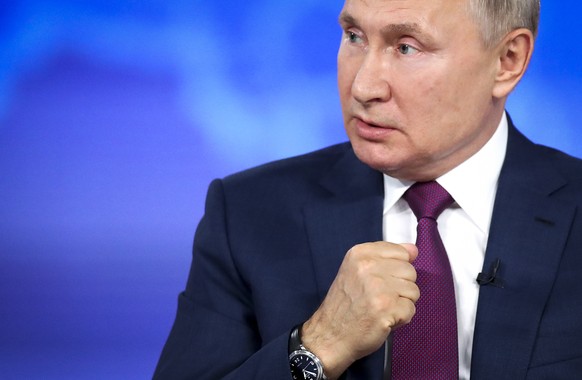 Russian President Vladimir Putin gestures during his annual live call-in show in Moscow, Russia, Wednesday, June 30, 2021. Putin says a U.S. reconnaissance aircraft was operating in sync with a Britis ...