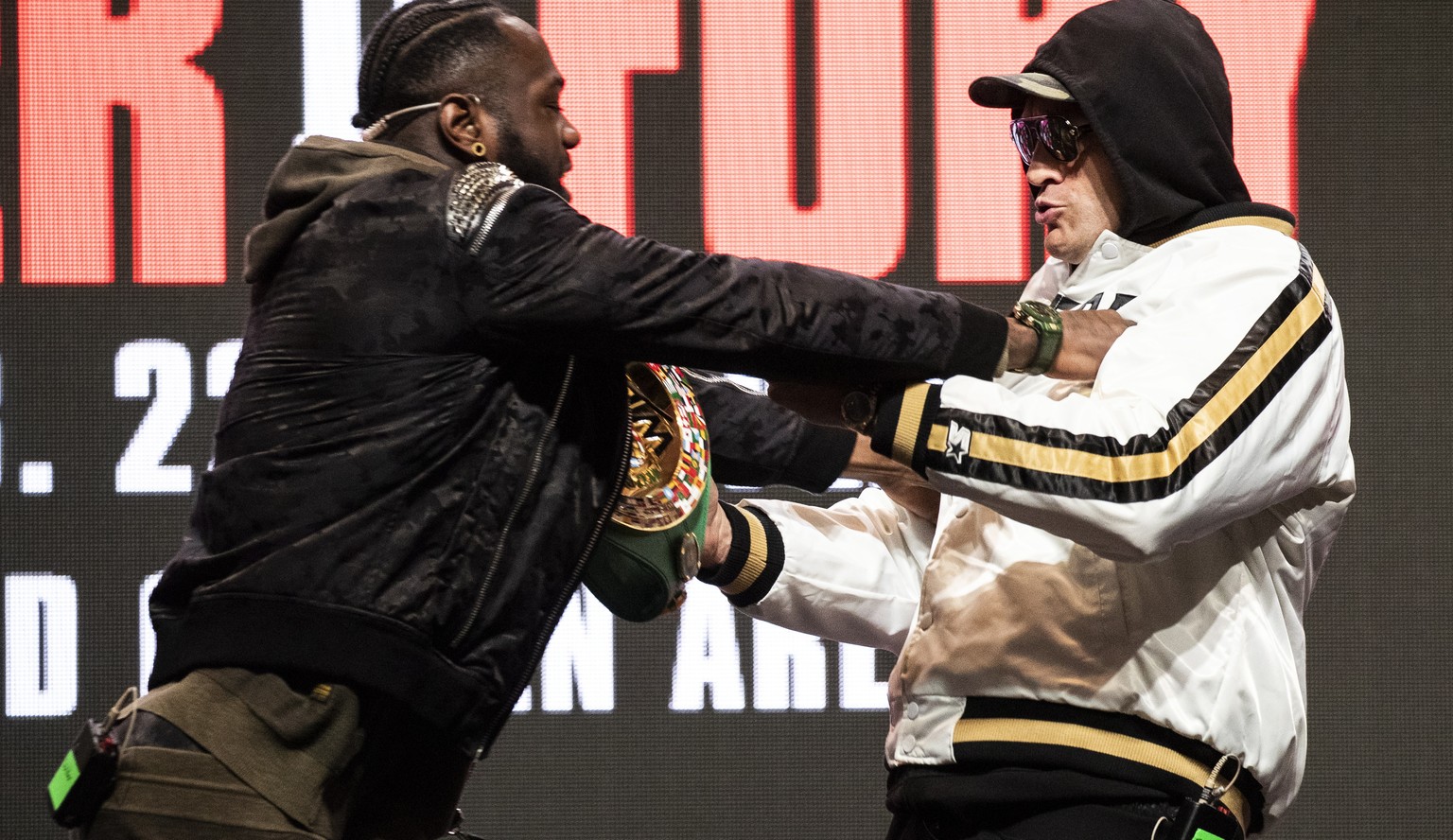 epa08229322 Heavyweight US boxer Deontay Wilder (L) and heavyweight British boxer Tyson Fury shove each other on stage during their last press conference before their rematch for the WBC Heavyweight W ...