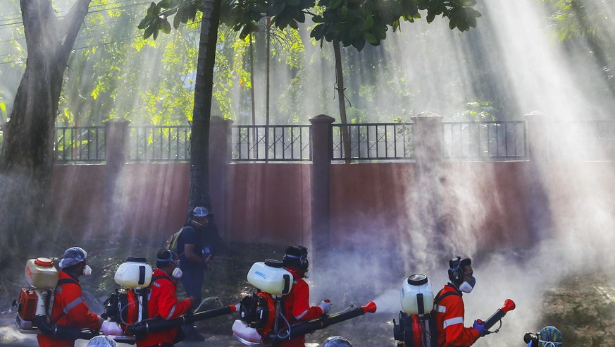 epa08327953 City Hall health officials wearing protective suits disinfect the entrance of Sri Petaling mosque in Kuala Lumpur, Malaysia, 28 March 2020. According to Malaysia?s Health Director-General ...
