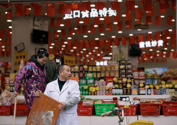 epa11203194 People walk in front of the supermarket in Shanghai, China, March 6, 2024 (released March 7, 2024).  According to information from the General Administration of Customs, China has…