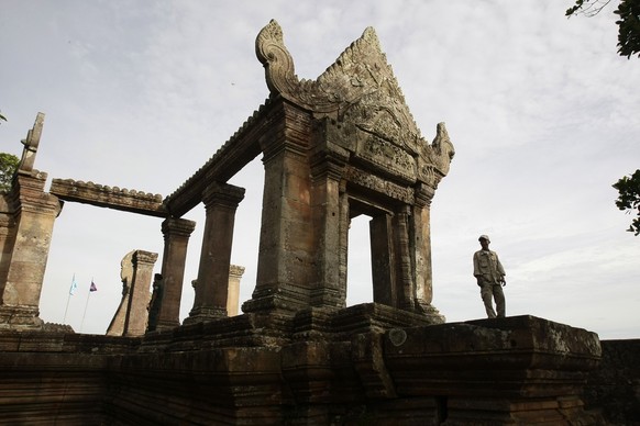 A Cambodian temple security guard stands at Preah Vihear temple, in Preah Vihear province, about 245 kilometers (152 miles) north of Phnom Penh, Cambodia, Wednesday, July 18, 2012. Nearly 500 Cambodia ...