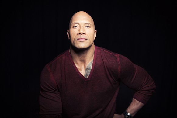 In this Dec. 8, 2014 photo, Dwayne "The Rock" Johnson poses in New York to promote his TNT reality series "Wake Up Call," premiering Friday at 9 p.m. ET. Johnson, 42, will help peo ...