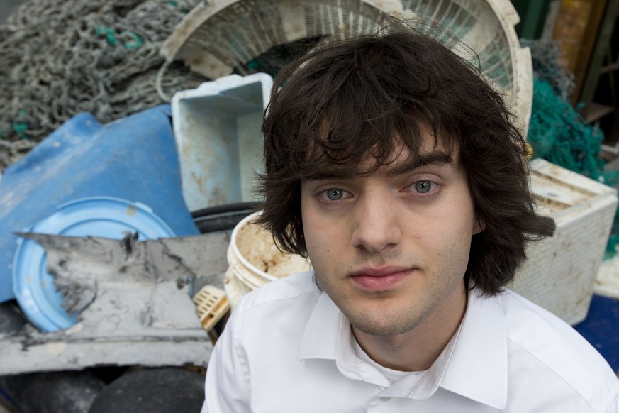 FILE - In this May 11, 2017, file photo, Dutch innovator Boyan Slat poses for a portrait next to a pile of plastic garbage prior to a press conference in Utrecht, Netherlands. A trash collection devic ...